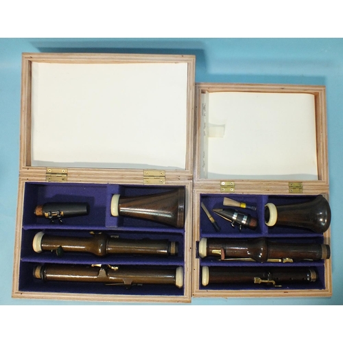 540 - A rosewood classical clarinet in A, with brass keys and another, similar, in A, (both boxed), (no ma... 