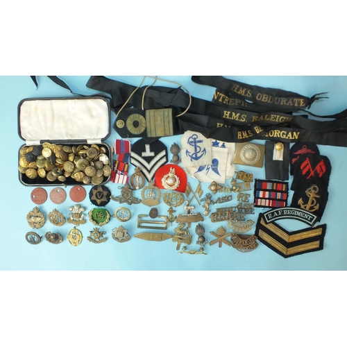 600 - A collection of various military badges, including R.F.C, Tank Corps, buttons, naval cap tallies inc... 