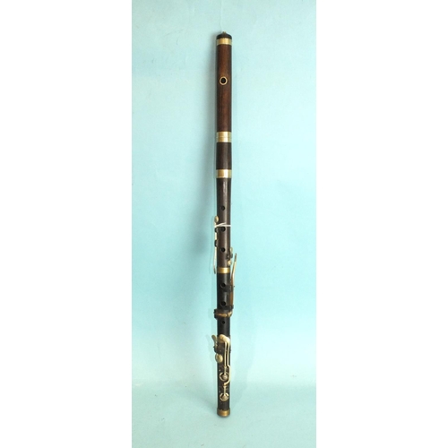 552 - A 19th century rosewood eight-keyed flute, 67cm.