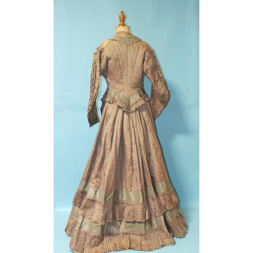 512 - A Victorian hand-stitched brown silk skirt, decorated with two flounces and taupe silk panels, a hea... 