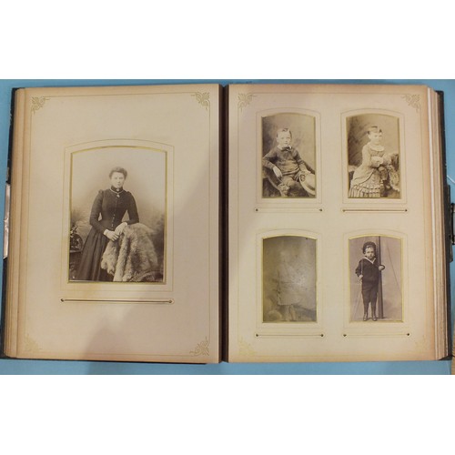 111 - An album of seventy-three cartes de visite, including a cabinet card of a midget couple stood on a t... 