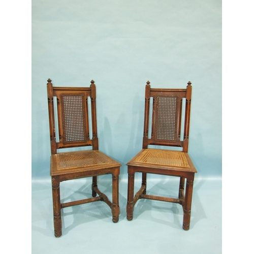 102 - A pair of Gothic-style oak hall chairs, each chamfered frame with caned back and seat (2).... 