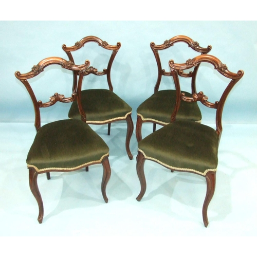 106 - A set of four Victorian rosewood dining chairs, each with carved and foliate back and  cabriole fron... 