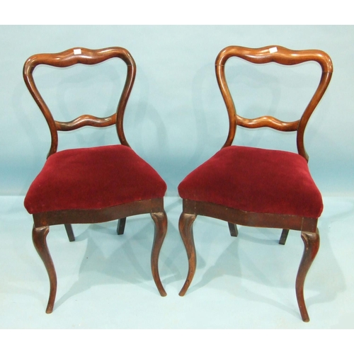 106 - A set of four Victorian rosewood dining chairs, each with carved and foliate back and  cabriole fron... 