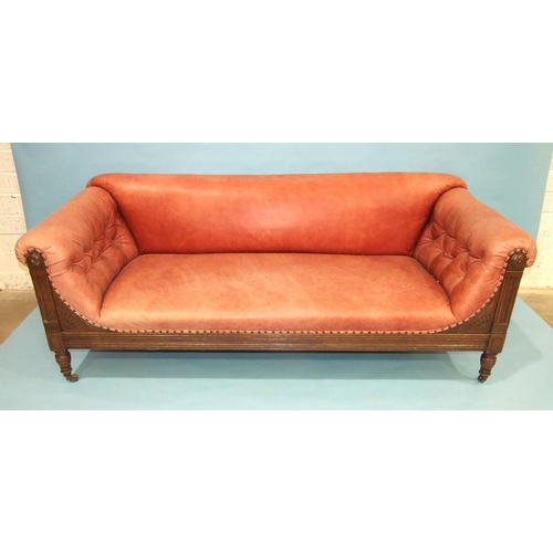 107 - A late-19th/early-20th century oak settee with carved and reeded frame, buttoned arms, plain seat an... 