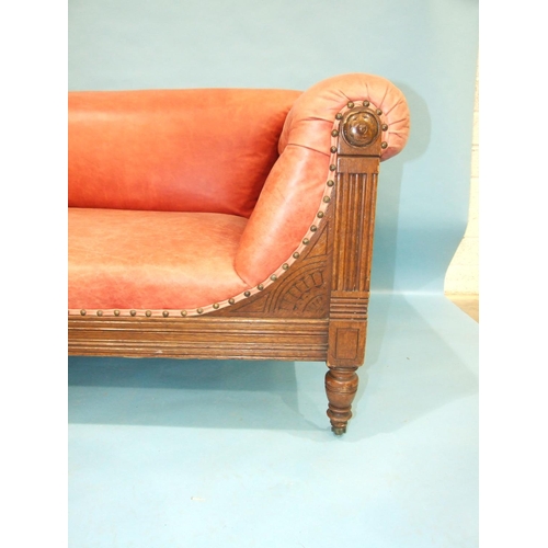 107 - A late-19th/early-20th century oak settee with carved and reeded frame, buttoned arms, plain seat an... 