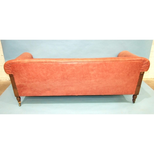 107 - A late-19th/early-20th century oak settee with carved and reeded frame, buttoned arms, plain seat an... 