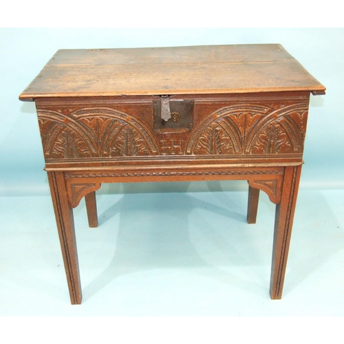 109 - An antique carved oak bible box on later stand, 76cm wide, 72cm high.