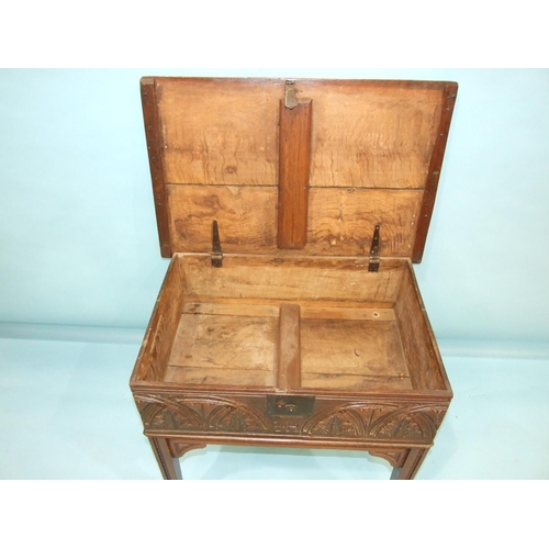 109 - An antique carved oak bible box on later stand, 76cm wide, 72cm high.