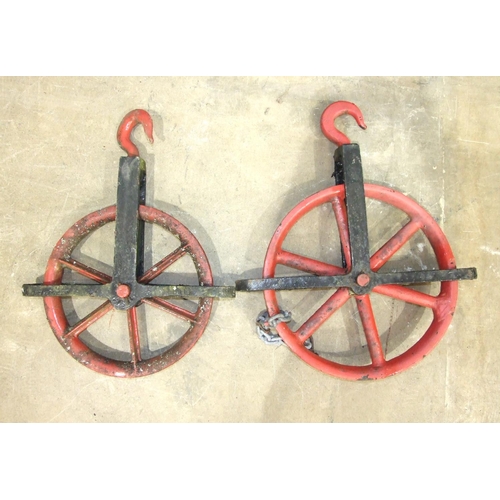 119 - A large cast iron pulley wheel, 55cm diameter and a smaller pulley wheel, 48cm diameter, (2).... 