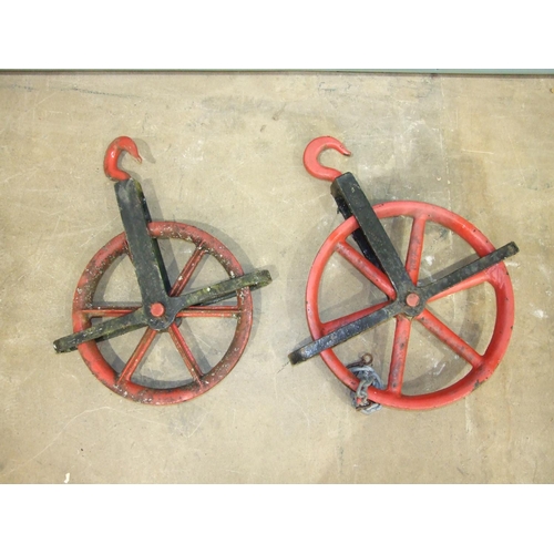 119 - A large cast iron pulley wheel, 55cm diameter and a smaller pulley wheel, 48cm diameter, (2).... 