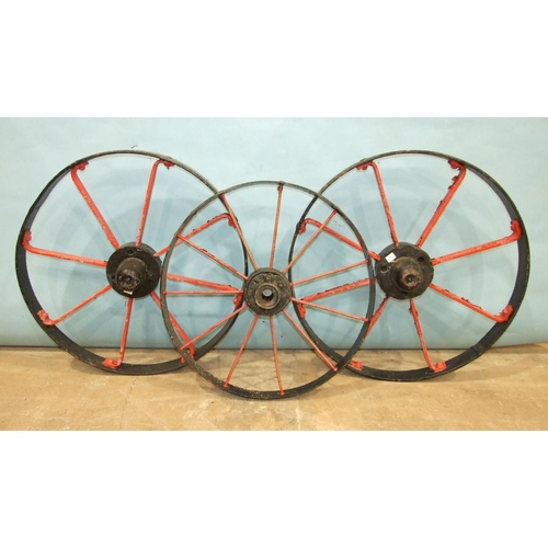 120 - A pair of iron-spoked cart wheels, 72cm diameter and a smaller iron-spoked wheel, 63cm diameter, (3)... 