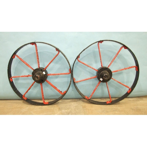 120 - A pair of iron-spoked cart wheels, 72cm diameter and a smaller iron-spoked wheel, 63cm diameter, (3)... 