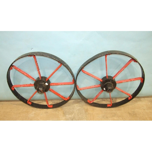 120 - A pair of iron-spoked cart wheels, 72cm diameter and a smaller iron-spoked wheel, 63cm diameter, (3)... 