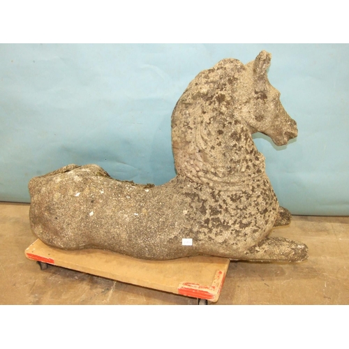 126 - A cast concrete model of a recumbent unicorn, horn and one ear missing, 85cm long, 60cm high.... 