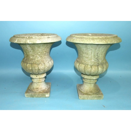 129 - A pair of white marble campana-shaped urns on square bases, 36cm high, 29.5cm diameter, (2).... 