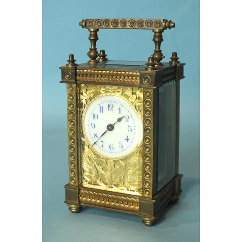137 - A late-19th/early-20th century brass carriage timepiece with ornate gorge case, the face with cut br... 