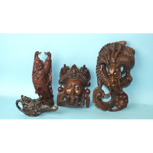 144 - A carved wood Chinese wall hanging in the form of a dragon, 26cm high, another in the form of a mask... 