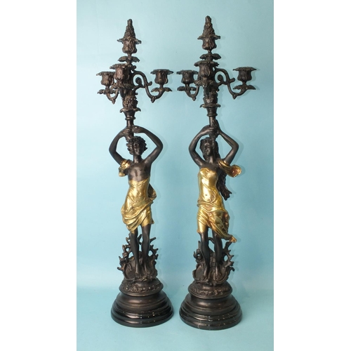 146 - After Emile Bruchon, a pair of reproduction bronzed metal figural candelabras, a male and a female f... 