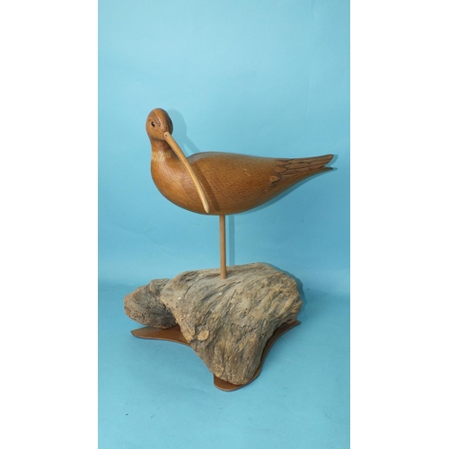 150 - A modern carved wood and poker-work painted model of an avocet on driftwood base, 34cm high, (chip t... 