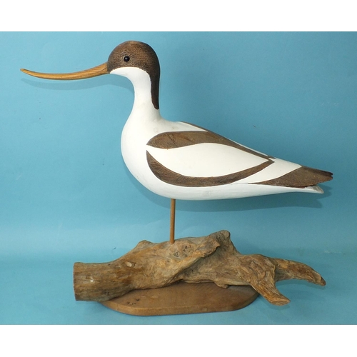 150 - A modern carved wood and poker-work painted model of an avocet on driftwood base, 34cm high, (chip t... 