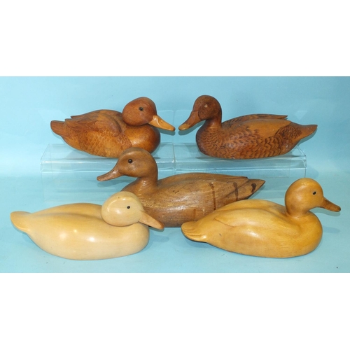 151 - A carved wood duck with carved feather detail signed 'A-J 95', 30cm long, 14cm high, another, (unfin... 