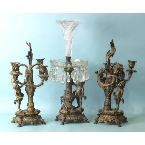 157 - A late-19th century bronzed metal and cut-glass epergne supported by a vase column and putti, on Roc... 