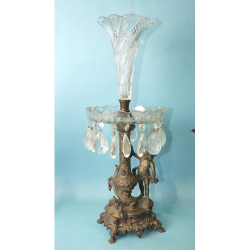 157 - A late-19th century bronzed metal and cut-glass epergne supported by a vase column and putti, on Roc... 