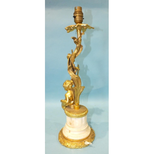 168 - A 20th century gilt brass and marble table lamp of foliate form, with a cherub seated on the fl... 