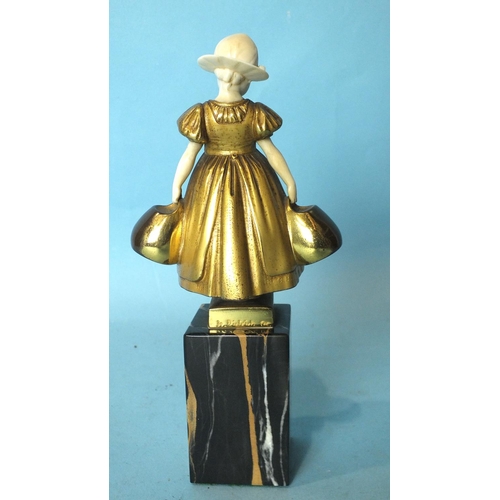 173 - H Dietrich, a bronze and ivory figure of a Dutch girl holding a basket in each hand, on veined marbl... 