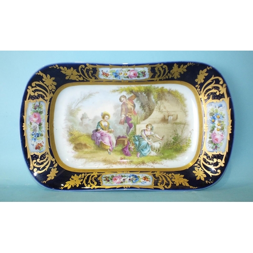 208 - A late Vienna oblong porcelain dish painted with a young man and two young ladies in a garden settin... 