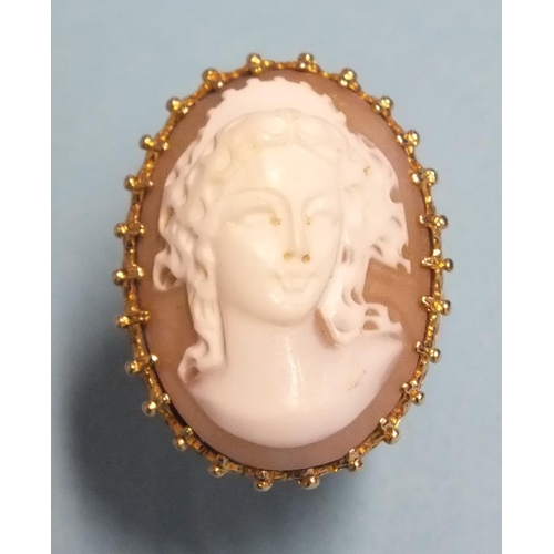 269 - A large 9ct gold ring set a shell cameo of a young woman, size K, 9.4g.