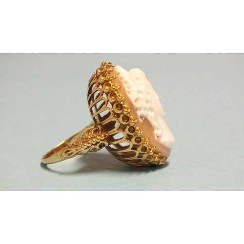 269 - A large 9ct gold ring set a shell cameo of a young woman, size K, 9.4g.