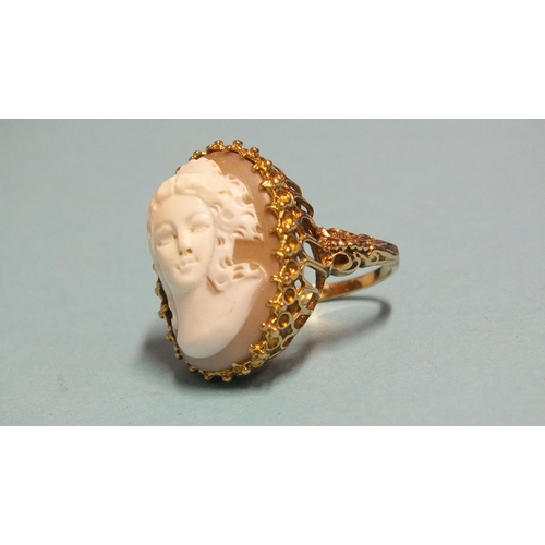 269 - A large 9ct gold ring set a shell cameo of a young woman, size K, 9.4g.