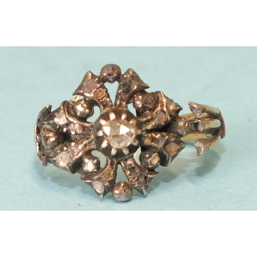 275 - A late 18th century diamond cluster ring, the central irregular rose-cut diamond in foil-back cut do... 