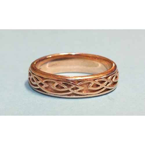 282 - A 9ct rose gold wedding band  with raised Celtic decoration, marked Clogau, 5mm wide, size O½, 4.1g.... 