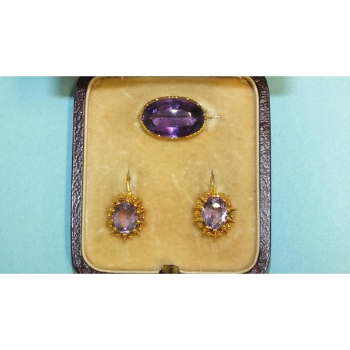 283 - A pair of Victorian amethyst earrings, 1.7cm long, the hook fitting with cannetile mounts, cased wit... 