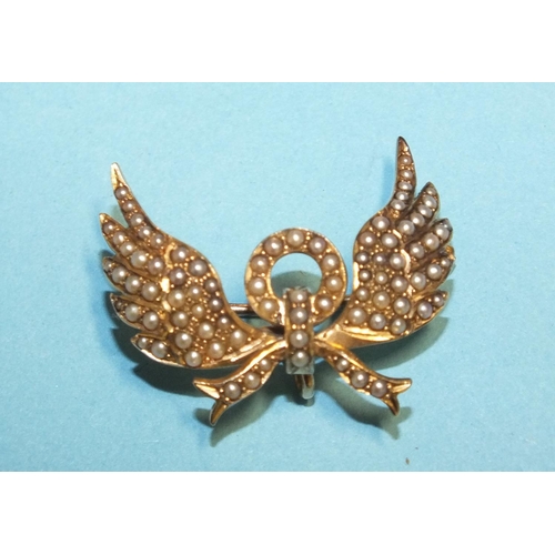 291 - A Victorian gold brooch in the form of wings and bow set seed pearls, (with hook for pendant at back... 