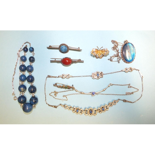 304 - A necklace of graduated sodalite and paste beads, a blue and white paste necklace, a small silver br... 