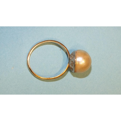 306 - A cultured pearl ring, the 9mm pearl, (cracked), on plain gold shank, (tests as 18ct approximately),... 