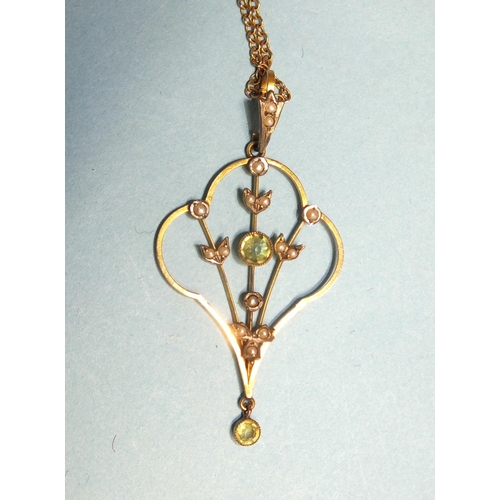 335 - An Edwardian 9ct gold open-work pendant set peridots and seed pearls, 5.5cm long, on 9ct gold chain ... 