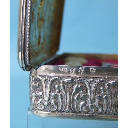 468 - A German silver etui of rectangular form, the lid with embossed scene of a couple and three children... 