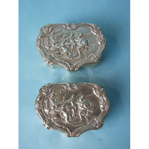 477 - A pair of shaped silver boxes with embossed lids and serrated bases, London 1894, (2).... 