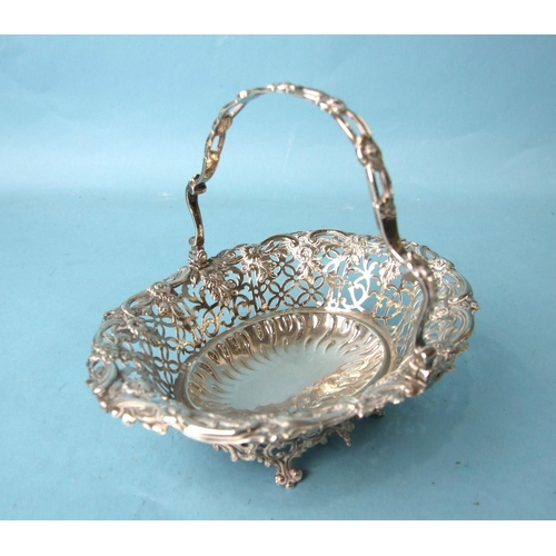 503 - A George III oval pierced sweetmeat basket, the handle and body pierced with flower heads and foliag... 