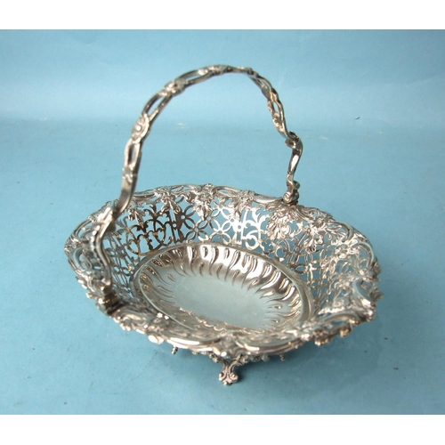 503 - A George III oval pierced sweetmeat basket, the handle and body pierced with flower heads and foliag... 