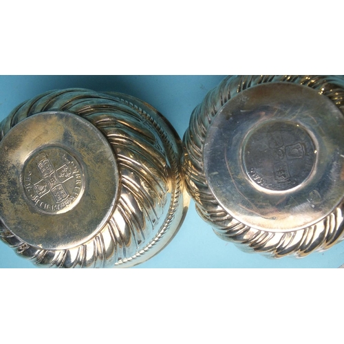 518 - A pair of Victorian circular bowls with half-gadrooned decoration, each inset with a coin, London 18... 