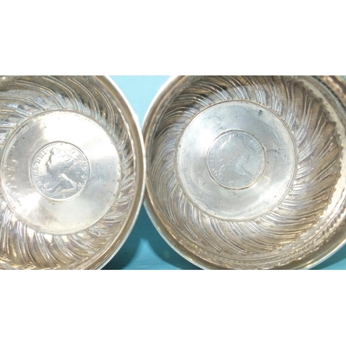 518 - A pair of Victorian circular bowls with half-gadrooned decoration, each inset with a coin, London 18... 