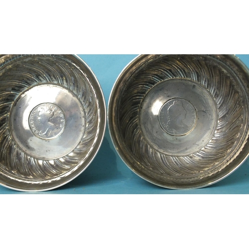 518 - A pair of Victorian circular bowls with half-gadrooned decoration, each inset with a coin, London 18... 