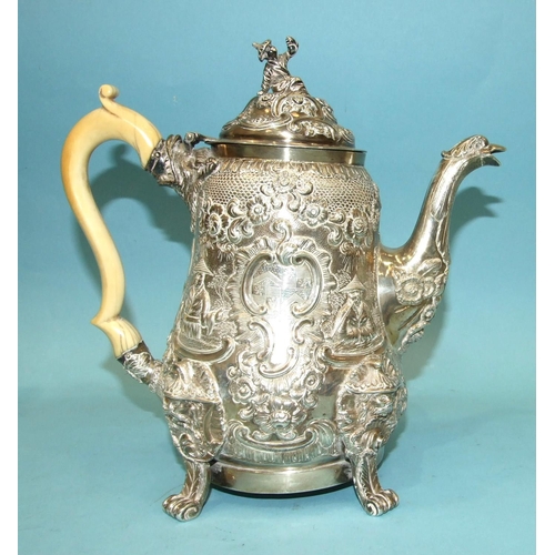 523 - A Regency coffee pot of slightly-bellied form, the figural finialled lid and shaped ivory handle to ... 