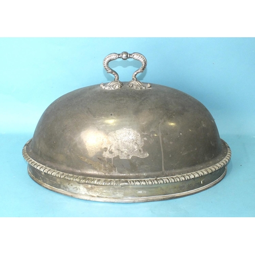 527 - A large oval meat dish cover with foliate handle and gadrooned border, bearing the Bastard family ar... 